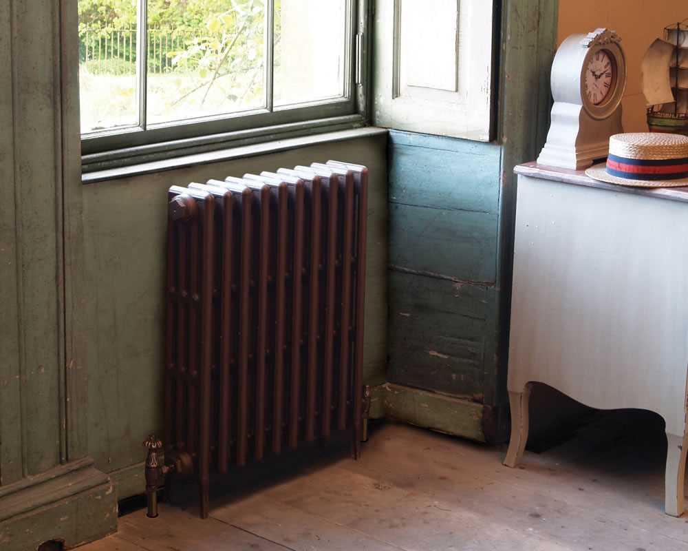 victorian painted column radiator under window in period property